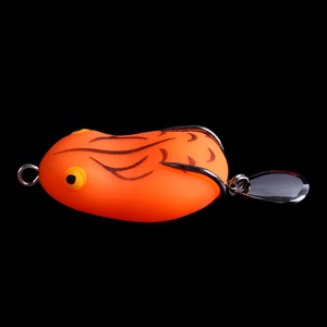 Close-up of orange bionic frog fishing lure with black stripes and dual barbed hooks