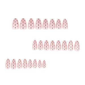 Almond-shaped press-on nails with nude cat-eye base and black polka dot design