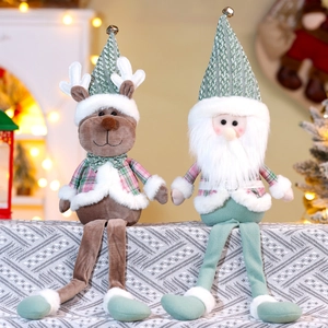 Detailed view of sitting Christmas plush dolls with reindeer and Santa in green plaid