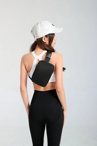 Rear view of model wearing a black waterproof nylon waist bag with quick release buckle