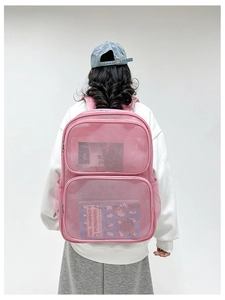 Detailed view of a pink breathable mesh backpack with double zippers worn by a model