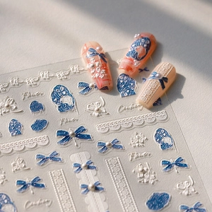 Stereo nail stickers with blue bows, white pearls, and lace flower textures for manicure