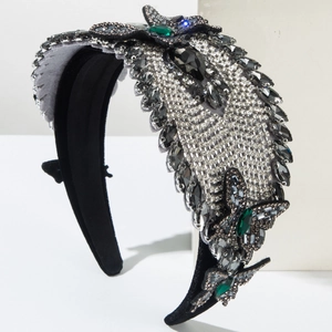 Close-up of luxury velvet headband with green rhinestone butterflies and crystals