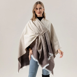 Close-up of beige and brown striped shawl with fringe detail on a female model