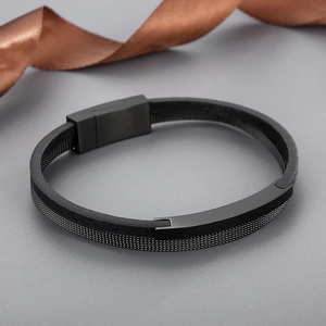 Detail of black leather and steel mesh bracelet with magnetic clasp on silk ribbon