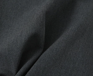 Macro view of dark gray twill fabric texture with elegant folds for dress material