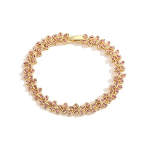 Detailed view of a gold flower bracelet featuring delicate pink crystals and a secure clasp