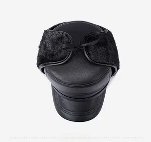 Top view of men's winter leather flat cap with black faux fur ear flaps and ribbon tie