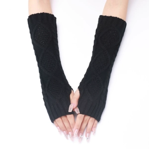 Macro shot of black diamond knit arm warmers with fingerless thumb hole design