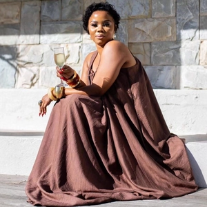 Elegant brown maxi dress with pleated texture and wide hem for a relaxed summer vacation