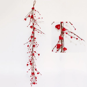 Detail of red heart-shaped berries and brown rattan branch on Valentine's Day wreath