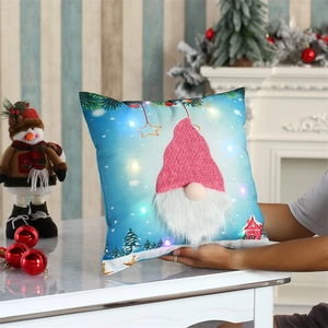 Close-up of LED glowing Christmas pillow cover with knit gnome and soft plush beard detail