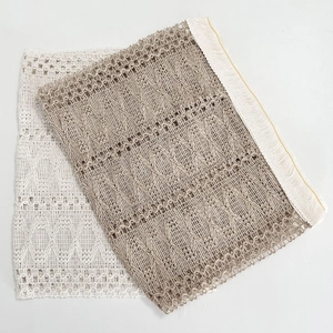 Detailed view of woven cotton linen coasters with vintage hollow-out pattern and tassels