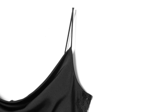 Detailed macro view of black satin slip dress with delicate lace trim and thin straps