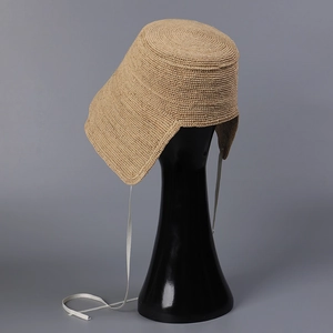 Elegant Raffia straw sun hat with asymmetrical brim and white ribbons for beach vacations