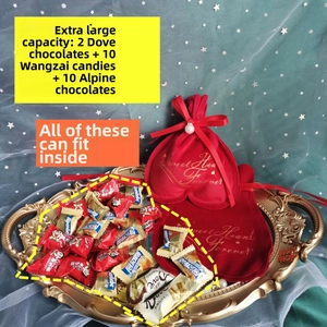 Detail of red heart-shaped velvet drawstring pouch with gold text and pearl accent