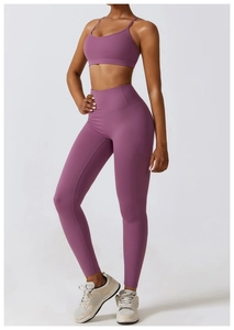 Detail of high-waist yoga leggings and thin strap sports bra in elegant mauve purple