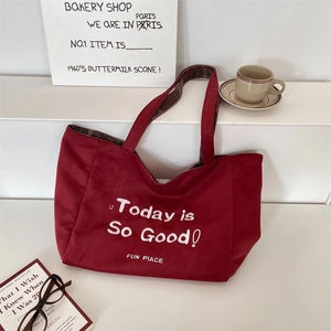Detail of red canvas tote bag with check lining and Today is So Good typography