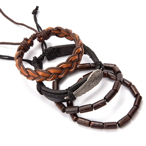 Detail of multi-layer leather bracelets with silver feather charm and dark wooden beads