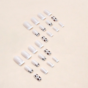 French tip press-on nails featuring minimalist nude base and stylish leopard print patterns