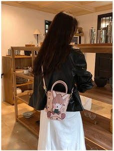 Detailed back view of model wearing pink bucket bag with 3D bunny and vintage prints