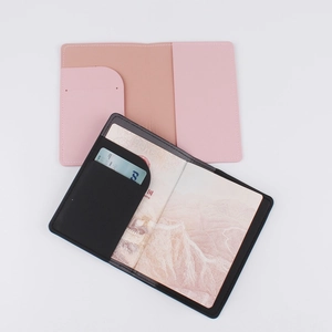 Pink and black leather passport holders with internal card slots for travel organization