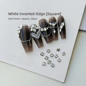 Detailed view of 3mm white square rhinestones applied on nails with silver chains