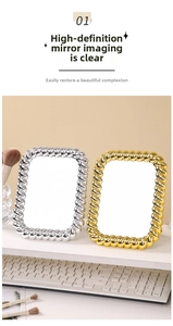 Detail of vintage gold and silver makeup mirrors with twisted metal rope frames on a desk
