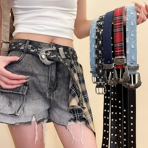 Close-up of Y2K star waist belt with retro engraved buckle and sequin denim textures
