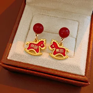 Elegant red and gold horse drop earrings with Success character in jewelry box