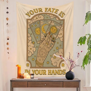 Detail of tarot tapestry showing 'YOUR FATE IS IN YOUR HANDS' text with sun and moon icons