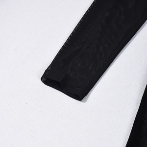 Close-up of black mesh fabric detailing on long sleeve cuff of sexy slit maxi dress