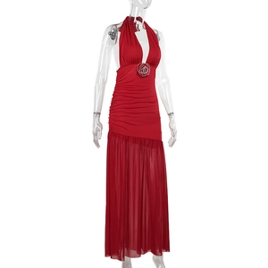 Detail of red halter dress featuring a 3D fabric rose and layered mesh tulle skirt