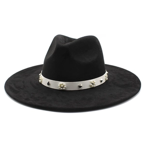 Detail of black wide-brim fedora with white band featuring pearls and silver studs