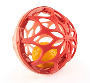 Close-up of red hollowed-out sensory ball featuring a yellow core for infant grip training