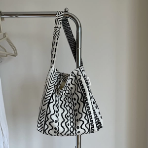 Detail of bohemian linen bag showing geometric print and 'simple wish' fabric label