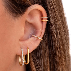 Macro shot of 18k gold plated geometric earrings and ear cuffs with micro pavé zircon
