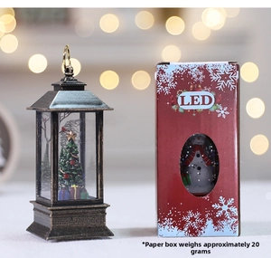 Close-up of vintage Christmas LED lantern with festive tree inside and red gift packaging