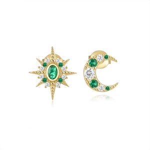 Detail of asymmetrical gold moon and star stud earrings with green and white crystals