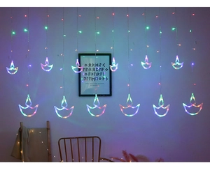 Close-up of Diwali LED curtain lights featuring colorful Diya shaped flame pendants