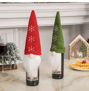 Detail of Christmas gnome wine bottle covers with snowflake embroidery and faux fur beards