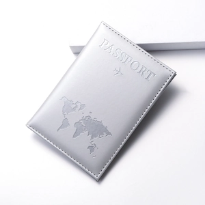 Detail of silver gray PU leather passport cover with world map and airplane embossing