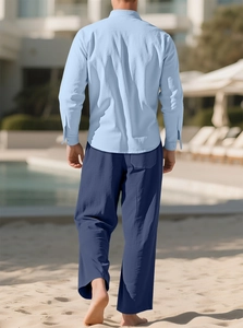 Men's light blue cotton linen shirt and dark blue trousers back view on beach