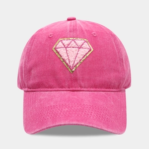 Close-up of pink baseball cap featuring diamond patch embroidery and sequin details