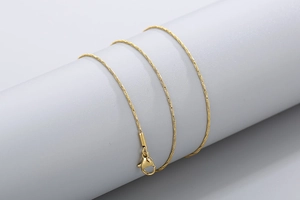 Detail shot of the flexible golden snake chain necklace with a lobster clasp closure