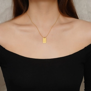 Minimalist stainless steel Taurus zodiac rectangle pendant necklace on a gold chain