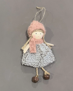 Close-up of handmade plush angel doll with pink knit hat, scarf and metal bells