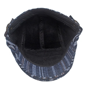Detail of 100% cotton inner lining and washing label on striped newsboy hat