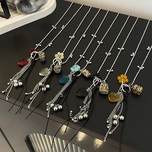 Detailed view of colorful heart crystal pendants with marble beads and silver tassels