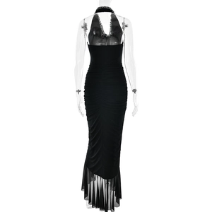 Detail view of black halter dress featuring ruched fabric and asymmetric mesh ruffle hemline
